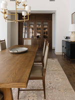 French farmhouse style dining table with solid pine legs and a solid bleached oak tabletop. Tapered, plank-style legs are finished in honey while angled joinery blocks add a unique touch. Seats eight comfortably.